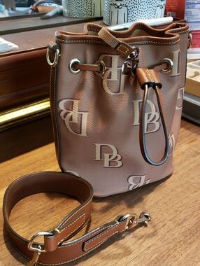 Dooney & Bourke Tan and Cream Monogram Bucket Bag